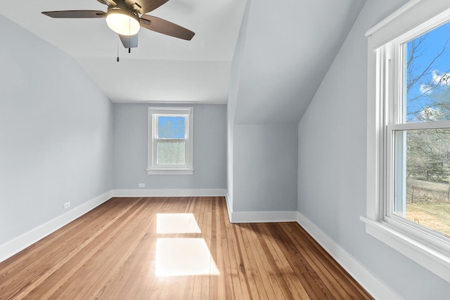 additional living space featuring ceiling fan, vaulted ceiling, and light wood-type flooring