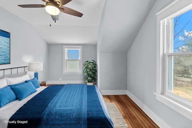 unfurnished bedroom featuring hardwood / wood-style flooring, ceiling fan, and lofted ceiling