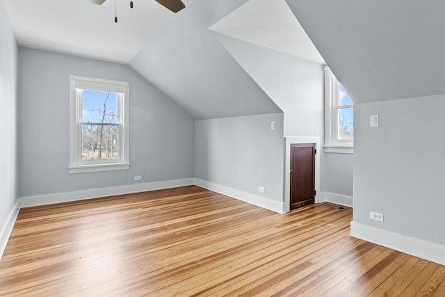 bonus room with ceiling fan, lofted ceiling, plenty of natural light, and light wood-type flooring