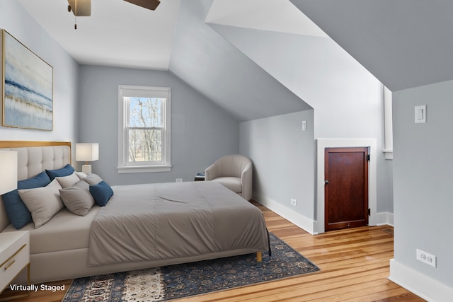 bedroom featuring lofted ceiling, light hardwood / wood-style floors, and ceiling fan