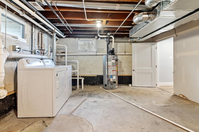 basement with gas water heater and washing machine and dryer