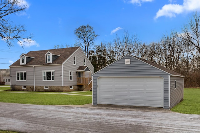 exterior space with a garage, an outdoor structure, and a front lawn