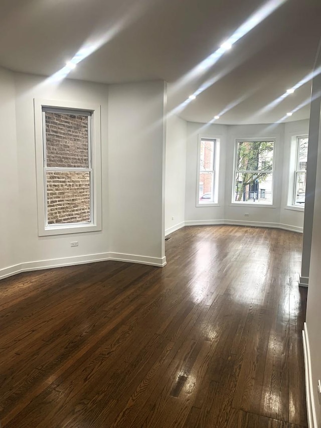 spare room featuring dark wood-type flooring