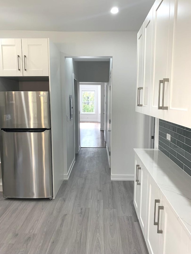 corridor with hardwood / wood-style flooring