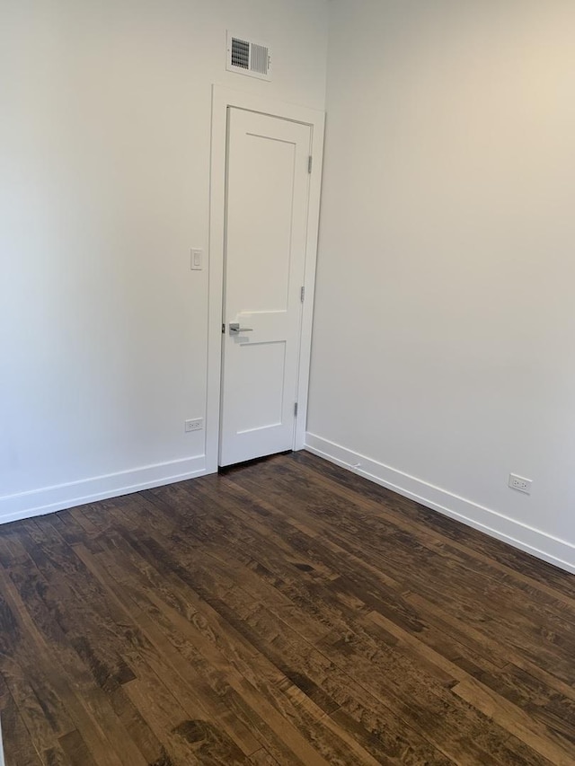 empty room featuring dark wood-type flooring