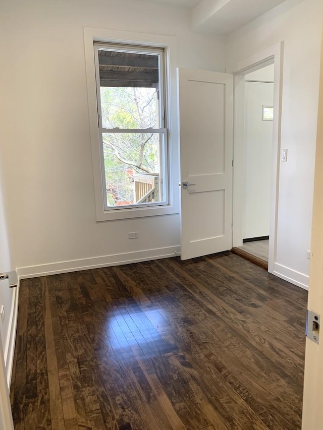 unfurnished room with dark hardwood / wood-style flooring