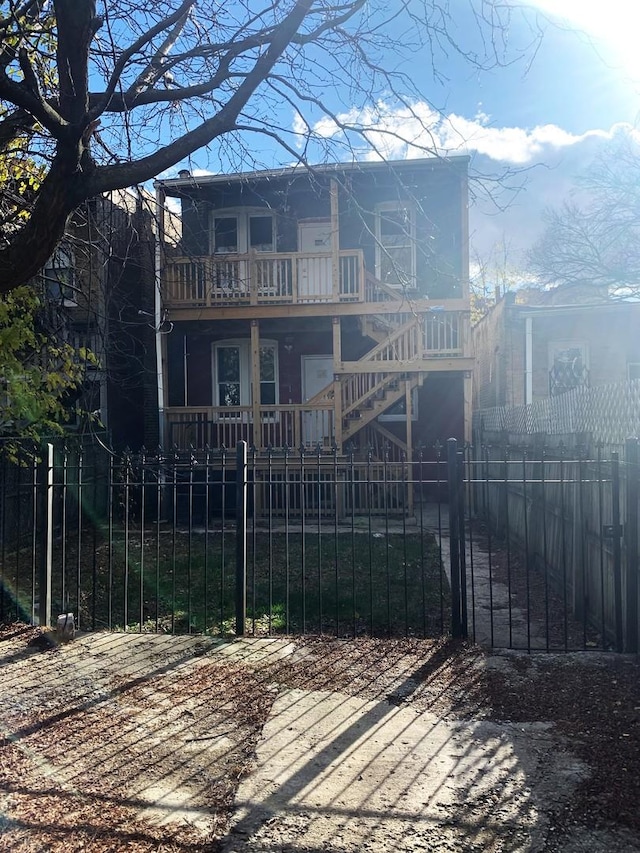 rear view of property with a balcony