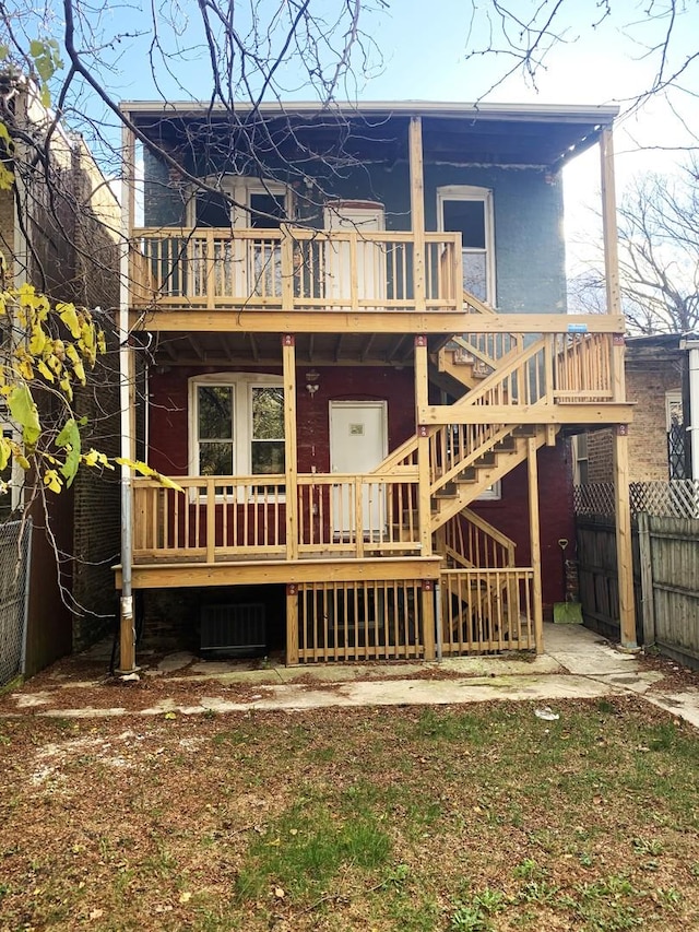 rear view of property with a wooden deck