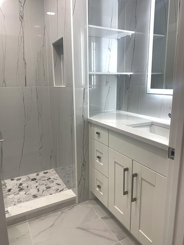 bathroom featuring vanity and a tile shower