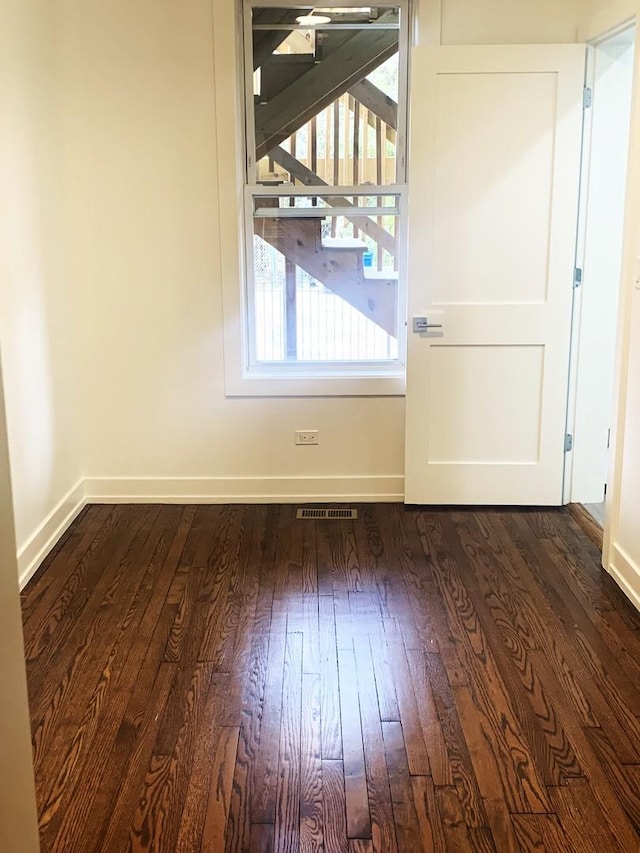 unfurnished dining area featuring dark hardwood / wood-style floors