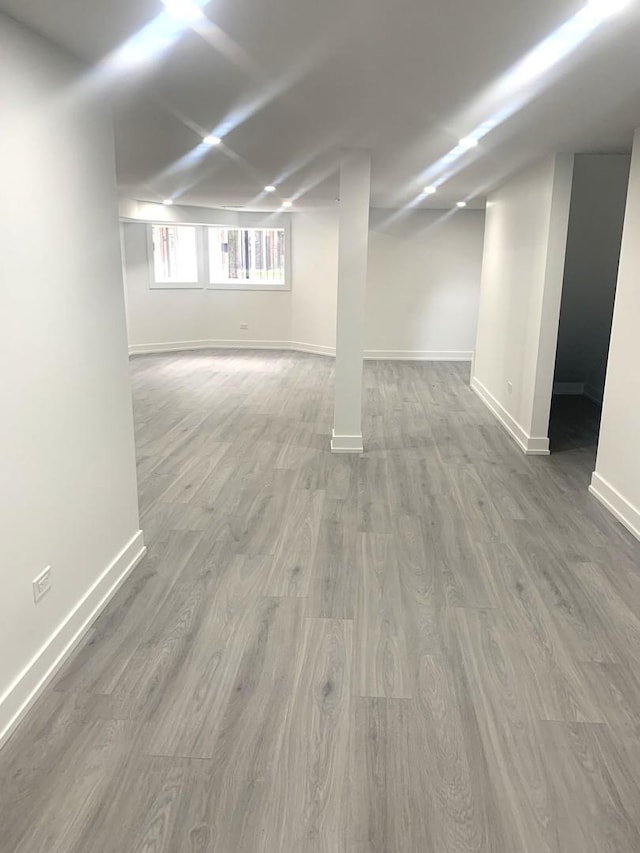 basement with hardwood / wood-style flooring