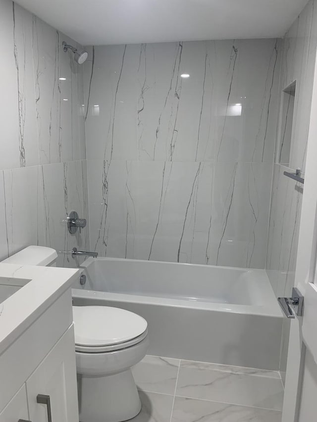 full bathroom featuring tiled shower / bath combo, vanity, and toilet