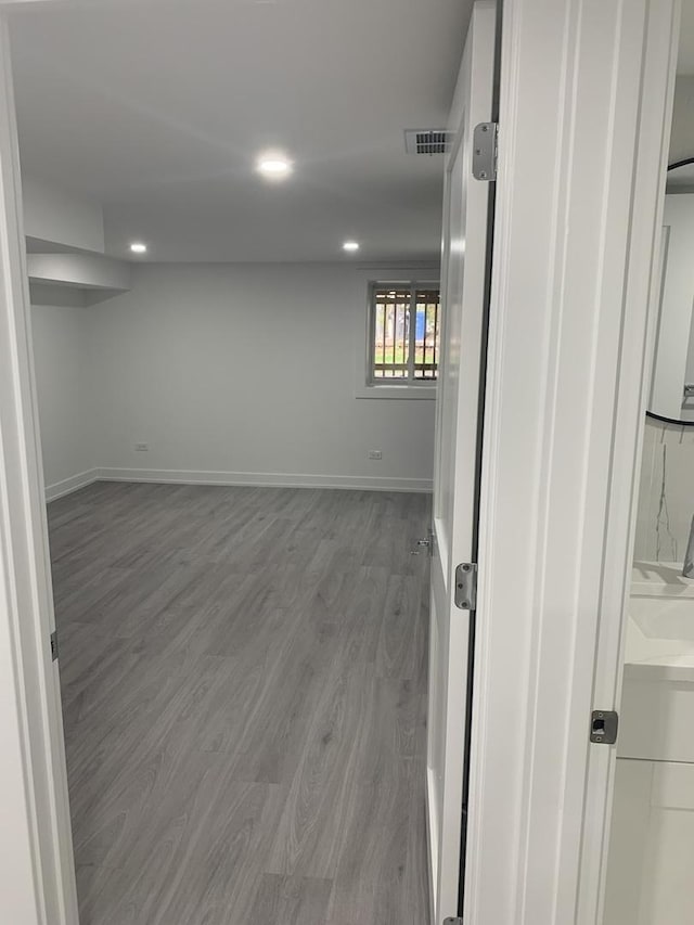 basement featuring hardwood / wood-style floors