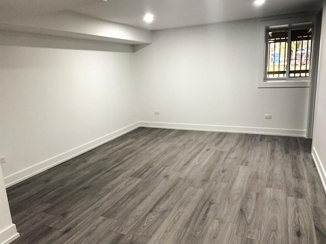 basement with dark hardwood / wood-style flooring