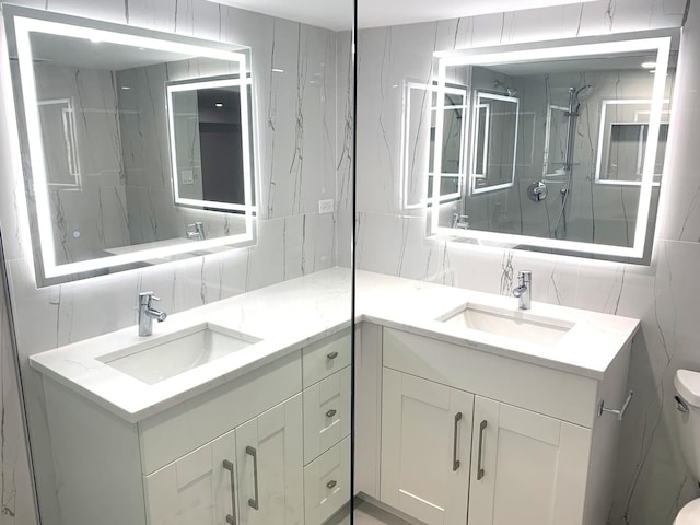 bathroom with tiled shower, toilet, tasteful backsplash, tile walls, and vanity