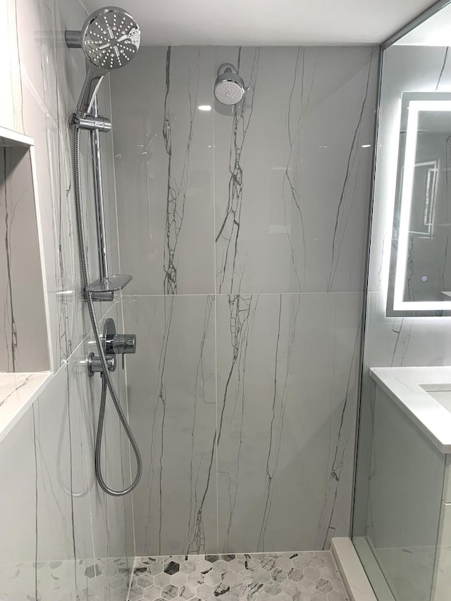 bathroom featuring vanity and tiled shower