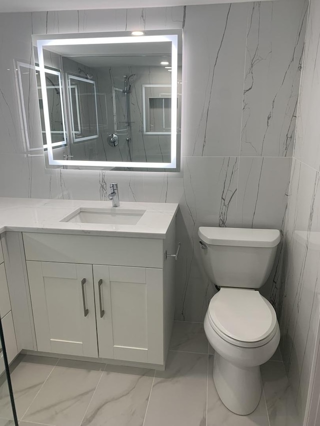 bathroom featuring vanity, toilet, and walk in shower