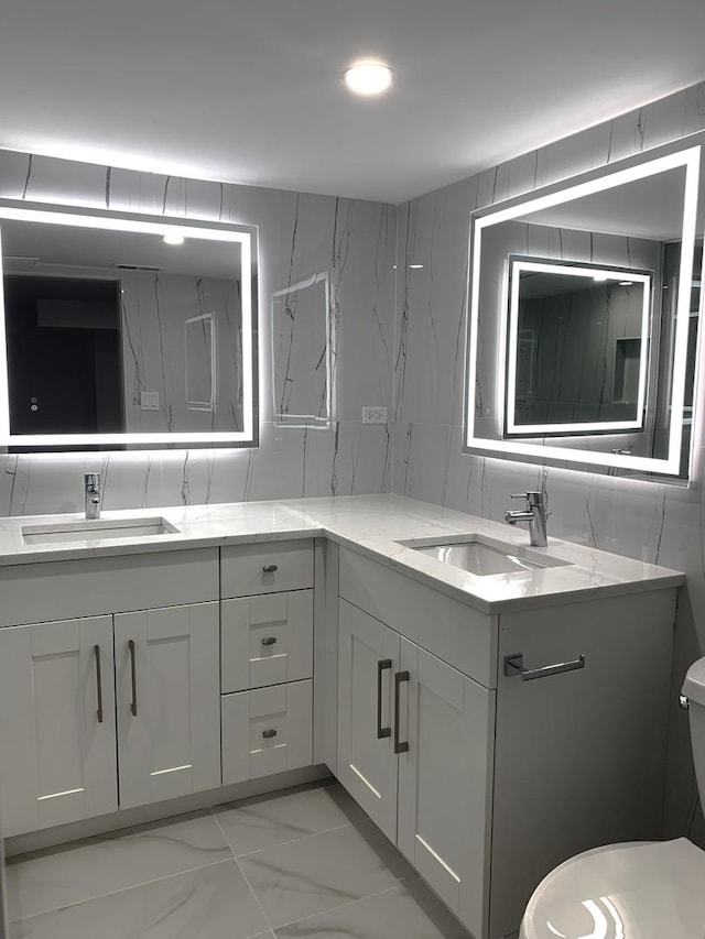 bathroom with vanity, decorative backsplash, tile walls, and toilet