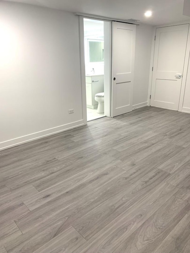 unfurnished room featuring sink and light wood-type flooring