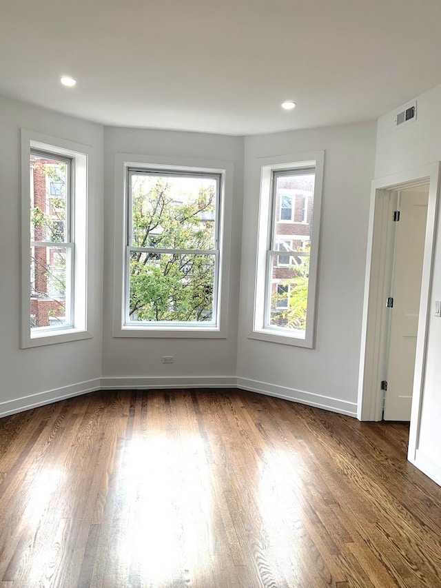 spare room featuring dark hardwood / wood-style flooring