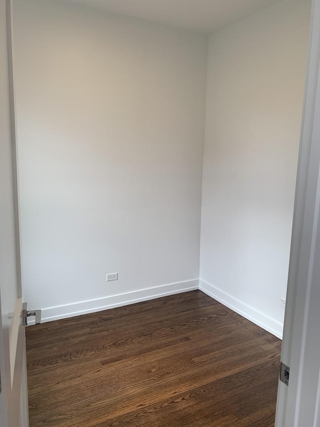 spare room featuring dark wood-type flooring