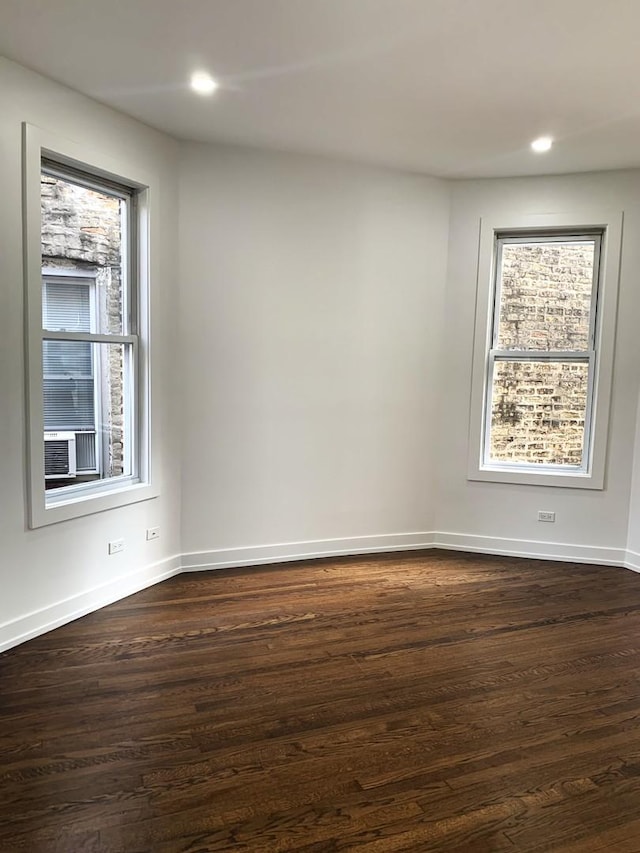 unfurnished room with dark hardwood / wood-style floors