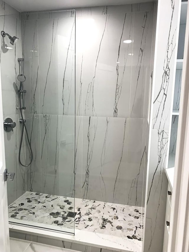 bathroom with tiled shower