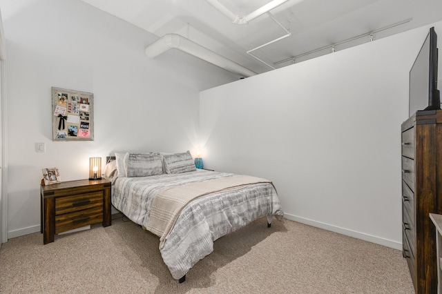 bedroom featuring light carpet