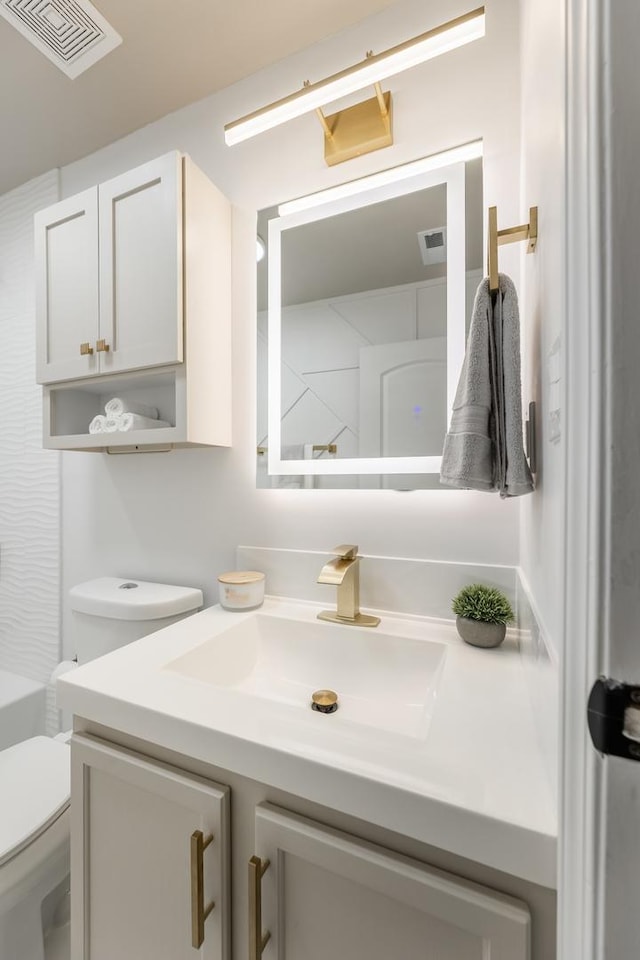 bathroom with vanity, toilet, and walk in shower