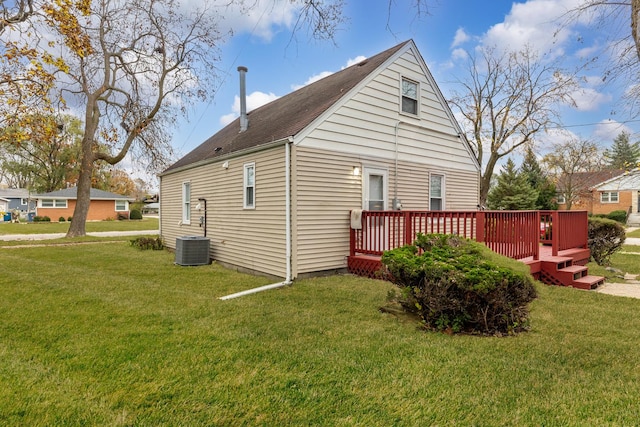 view of home's exterior with a wooden deck, a yard, and central AC unit