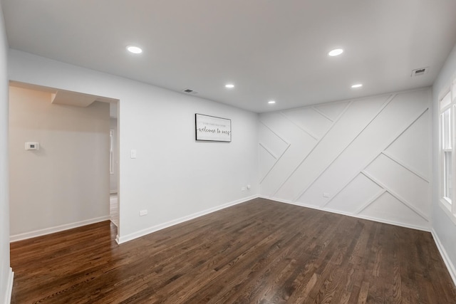 basement with dark hardwood / wood-style floors