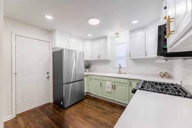 kitchen with white cabinetry, sink, stainless steel fridge, dark hardwood / wood-style flooring, and green cabinetry