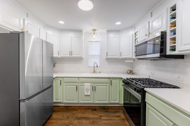 kitchen with sink, appliances with stainless steel finishes, dark hardwood / wood-style floors, green cabinets, and white cabinets