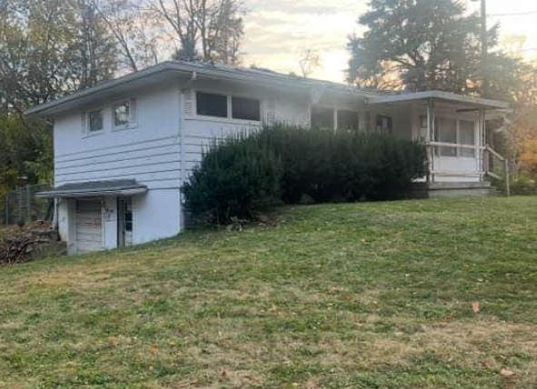 view of side of property with a yard