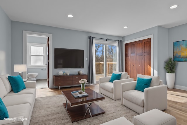 living room with plenty of natural light and light hardwood / wood-style floors