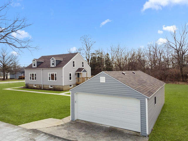 exterior space with a garage and a lawn