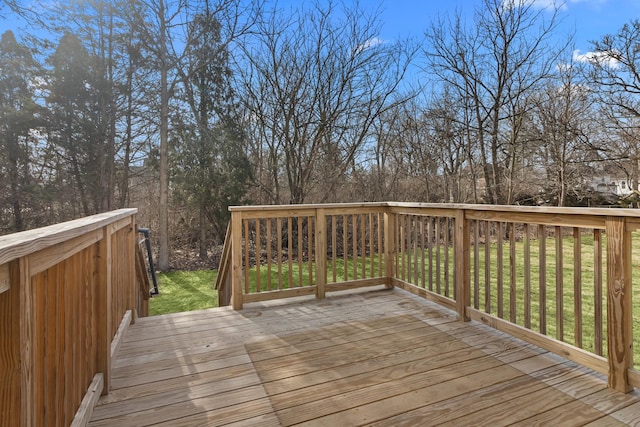 wooden terrace featuring a yard