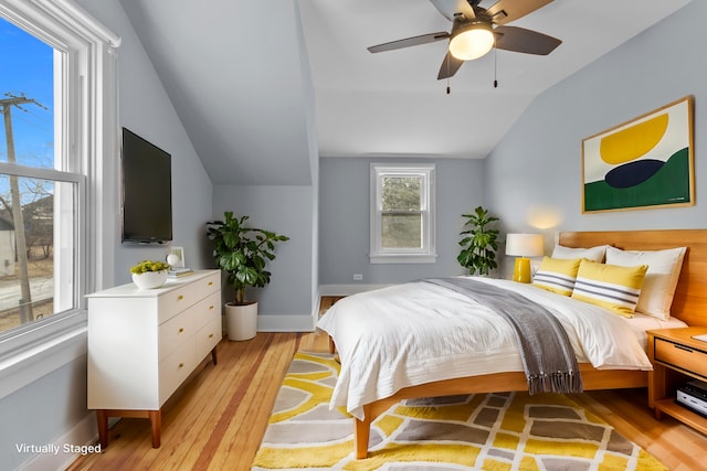 bedroom with lofted ceiling, light hardwood / wood-style floors, and ceiling fan