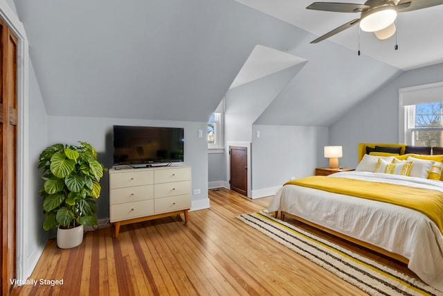 bedroom featuring ceiling fan, vaulted ceiling, and light hardwood / wood-style floors