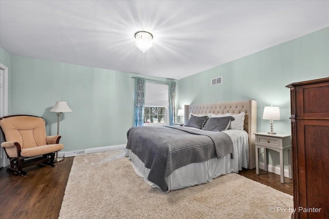 bedroom with dark hardwood / wood-style flooring