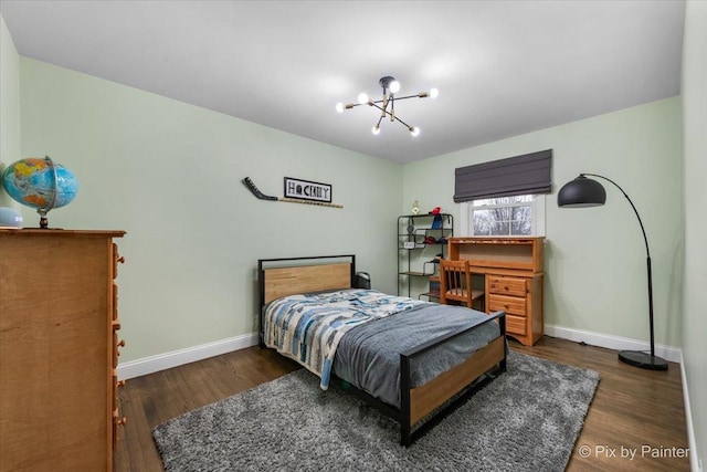 bedroom with dark hardwood / wood-style floors and a chandelier