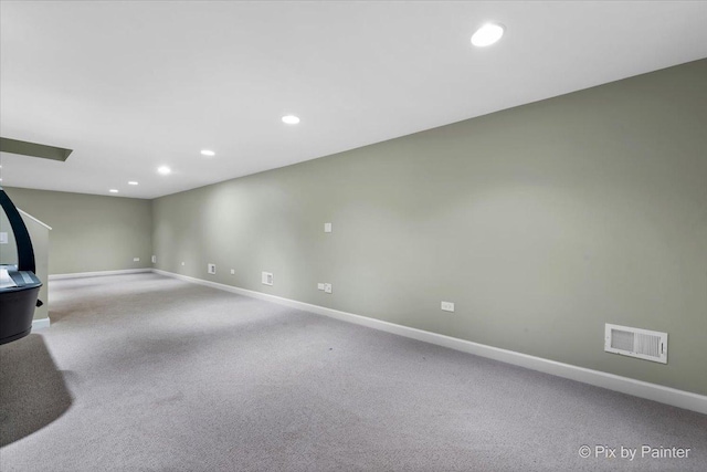 basement featuring light carpet