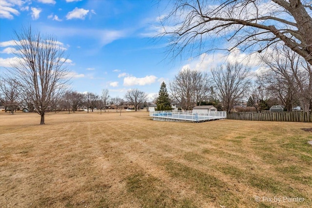 view of yard with a fenced in pool