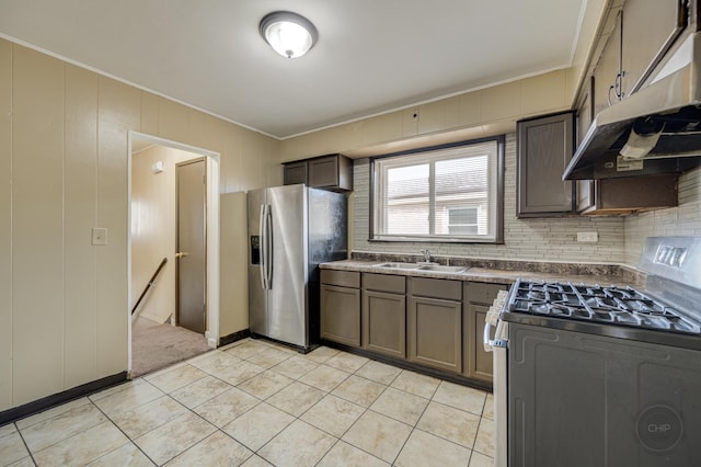 kitchen with crown molding, appliances with stainless steel finishes, sink, and light tile patterned floors