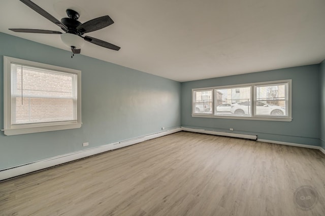 unfurnished room with ceiling fan, light hardwood / wood-style flooring, and a baseboard heating unit