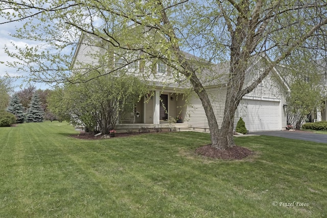 view of front of house with a garage and a front lawn