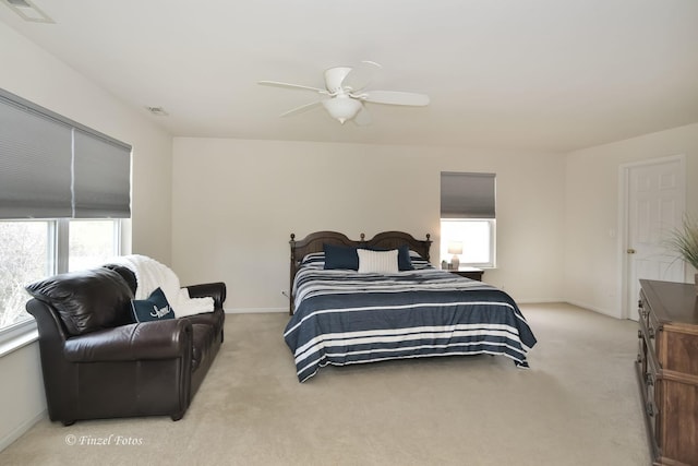 bedroom with ceiling fan and light carpet