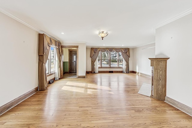 unfurnished living room with crown molding and light wood-type flooring