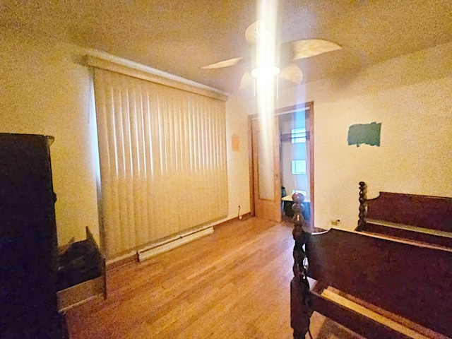 bedroom featuring hardwood / wood-style floors and ceiling fan