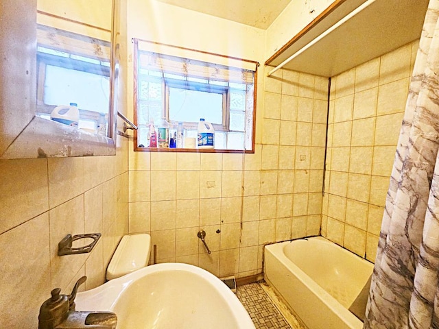 bathroom with shower / bath combo with shower curtain, toilet, and tile walls